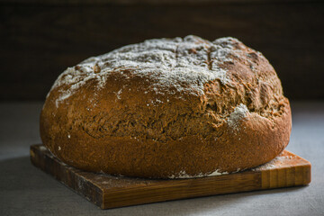 Homemade, special, Ukrainian bread on the kitchen table and a towel.