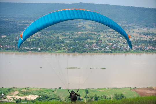Person Paragliding over Mekong river, Nong Khai, Thailand
