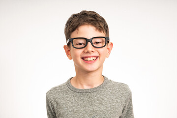 Cute satisfied smiling boy with glasses