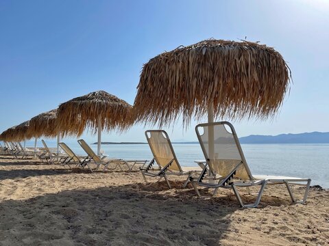 Row of sun loungers on Aquarius Beach, Skala, Agistri, Attica, Greece