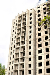 Construction of a residential building. Tower cranes building a new residential building. Unfinished panel house and construction crane