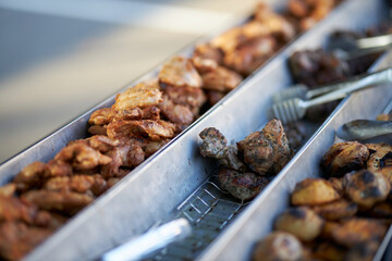 Grilled vegetables and chicken on distribution in iron trays , containers