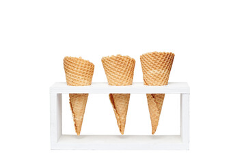 empty waffle cones in wood holder white background