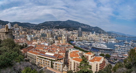 Naklejka na ściany i meble Panorama shot of Monaco City and the harbour on a beautiful spring day