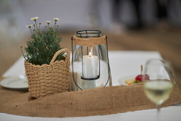 the table on the street is reserved, there is a candle and daisies on the table.