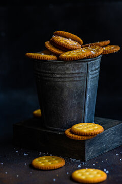 Salted cracker cookies in a metal bucket on a table