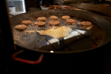 Cooking cutlets for a burger. Their beef cutlets, cooking a burger