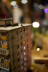 Miniature houses made by hand. Pieces of people and cars. Houses close-up 
