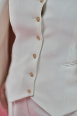 Women's white suit close-up on a pink background. solutions . Style and fashion 