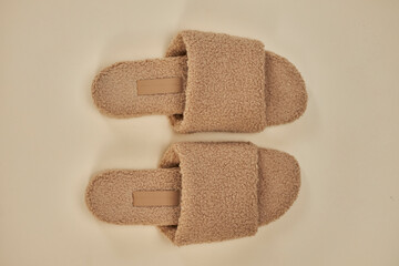 Homemade beige slippers. Cosiness . Home style.