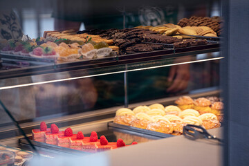Italian Pastries On Display of Confectionery Shop Stock Photo, sweet desserts view by the window of cafe.