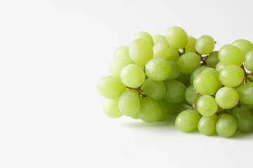 Bunch of green, white grapes on a white background. Seedless grape variety. Copy space.
