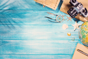 Top view of summer beach accessories on marine blue planks pier. Background with copy space and...