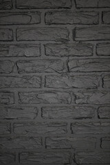 Texture of brick decorative wall in dark gray color 