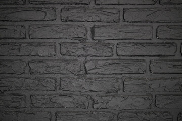 Texture of brick decorative wall in dark gray color 