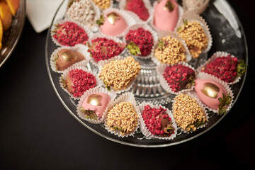 sweet dessert - strawberries in chocolate, strawberries with nuts, strawberries in sweet topping