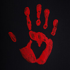 Red palm print on black background with heart, stop bloodshed and war, peace concept.