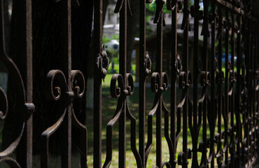 Black metal fence with monograms.