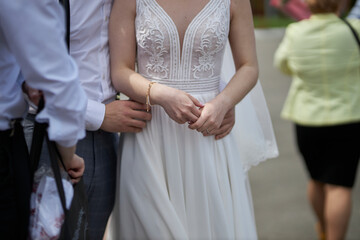 groom hugging bride, close-up of hands