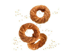 Three traditional turkish simit bagels with sesame flying falling isolated on white background. - obrazy, fototapety, plakaty