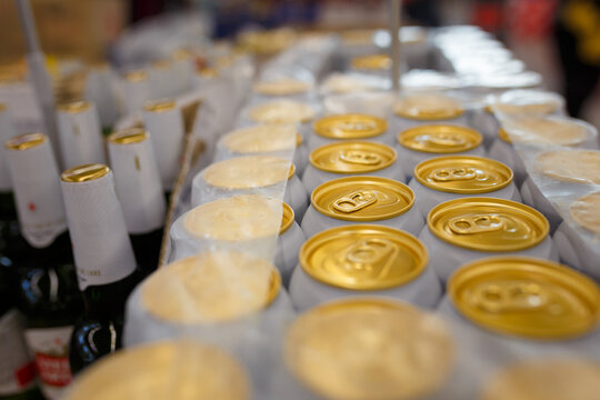 Soft Focused Close Up Shot Of Canned Beer In Plastic Package. Top Of Cans With Locking Rings