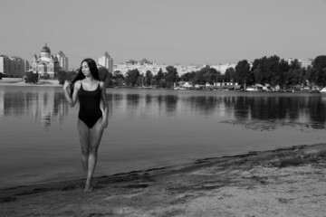 Fototapeta premium Beautiful woman in bikini at the river in black and white