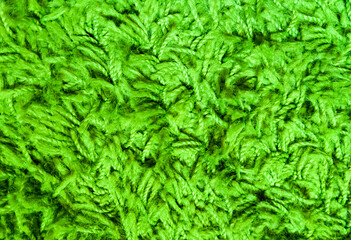 Naklejka na ściany i meble Green texture of pile, threads and wool. Close-up macro photo of the carpet