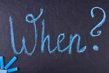 Question When written with blue chalk on black chalkboard. Query and assistance concept.