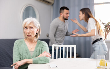 Offended elderly mother dont speaking with adult children during home quarrel