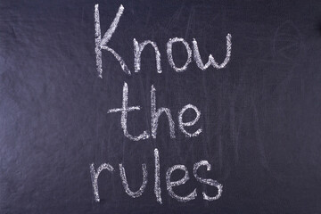 Know the rules inscription written chalk on black board. Business concept.