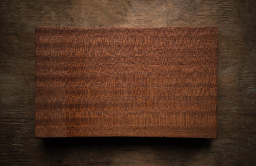 Rectangular block of mahogany for the manufacture of yachts. A sample of natural wood on the table.