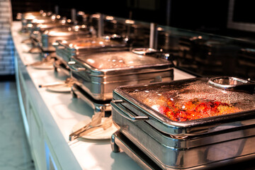 Catering buffet food with heated trays ready for service in hotel restaurant