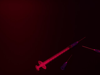 注射器と注射針で違法な薬物を連想させる怪しい雰囲気の写真
