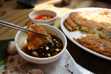 It is a Korean food made of soft young green onions mixed with flour and fried in oil.