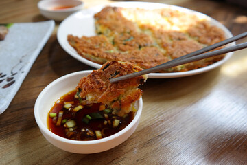 It is a Korean food made of soft young green onions mixed with flour and fried in oil.