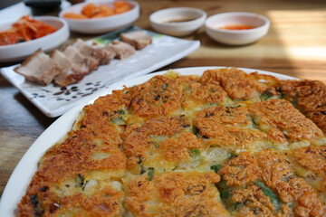 It is a Korean food made of soft young green onions mixed with flour and fried in oil.