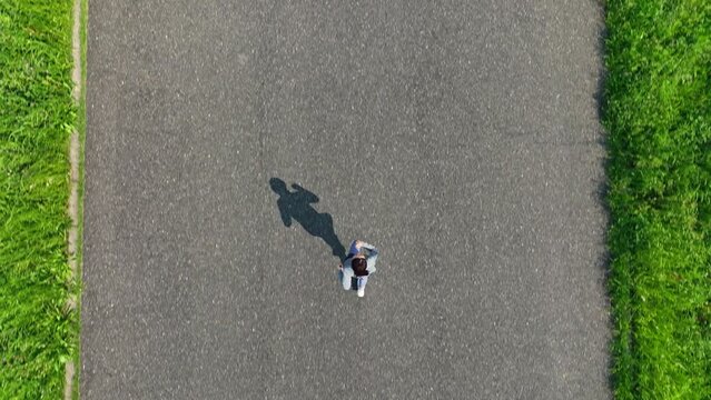 土手でジョギングする女性の空撮　真俯瞰