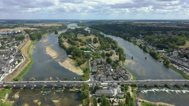 Aerial drone footage of Pont du Marechal Leclerc over Loire river with cars traffic. Sunny day, waves, green view of the island, between two sides of picturesque landscape. Amboise bridge. HD footage
