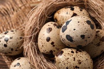 Obraz premium Nest with quail eggs on table, closeup