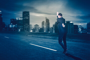 Rear view of businessman running fast on road