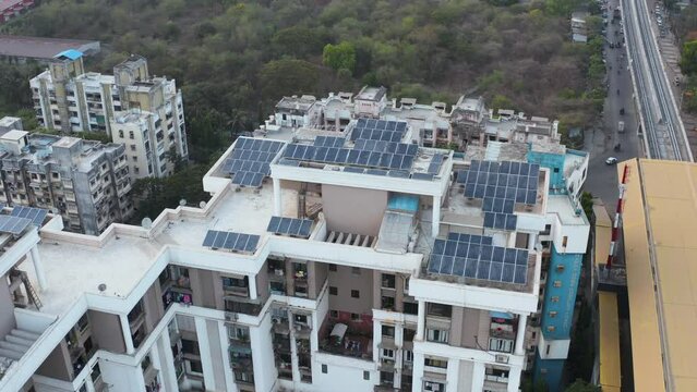 Mumbai, India. Aerial View of Solar Panels Array on Top of Residential Building in Suburban Neighborhood, Drone Shot
