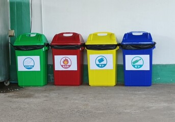 Japanese garbage assorting trashcans on the street. Japanese language in this picture means bottles, cans, PET bottles, combustible garbage, plastics,the garbage seperation in Japan concept.