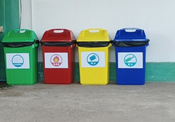 Japanese garbage assorting trashcans on the street. Japanese language in this picture means bottles, cans, PET bottles, combustible garbage, plastics,the garbage seperation in Japan concept.