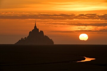 Beautiful sunset view of historic landmark Le Mont Saint-Michel in Normandy, France