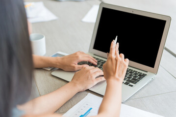 Business girls looking at laptop for presenting or discussing together in conference room during meeting at office