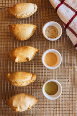 A table with empanadas and sauces