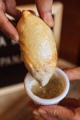 A table with empanadas and sauces