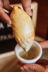 A table with empanadas and sauces