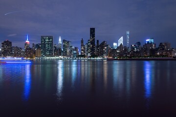 Fototapeta na wymiar New York City Manhattan midtown panorama at dusk with skyscrapers illuminated over east river