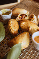 A table with empanadas and sauces